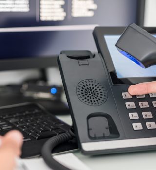 Communication support, call center and customer service help desk. VOIP headset on laptop computer keyboard.